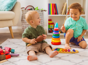 The little boys play with musical toys in kindergarten